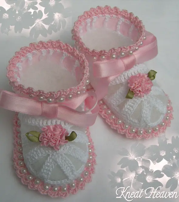 White and pink crochet baby booties with beads, bows and flowers