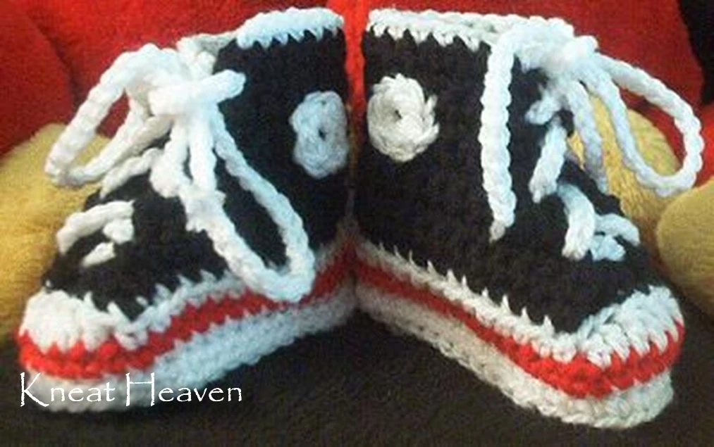 Handmade crochet baby sneaker booties with a contrasting stripe