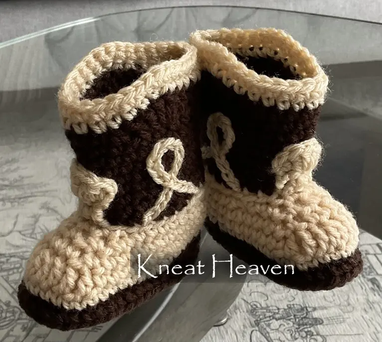Brown and tan crochet cowboy baby booties shown from the front