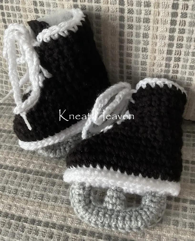 Black and white crochet baby hockey skate booties with grey blades