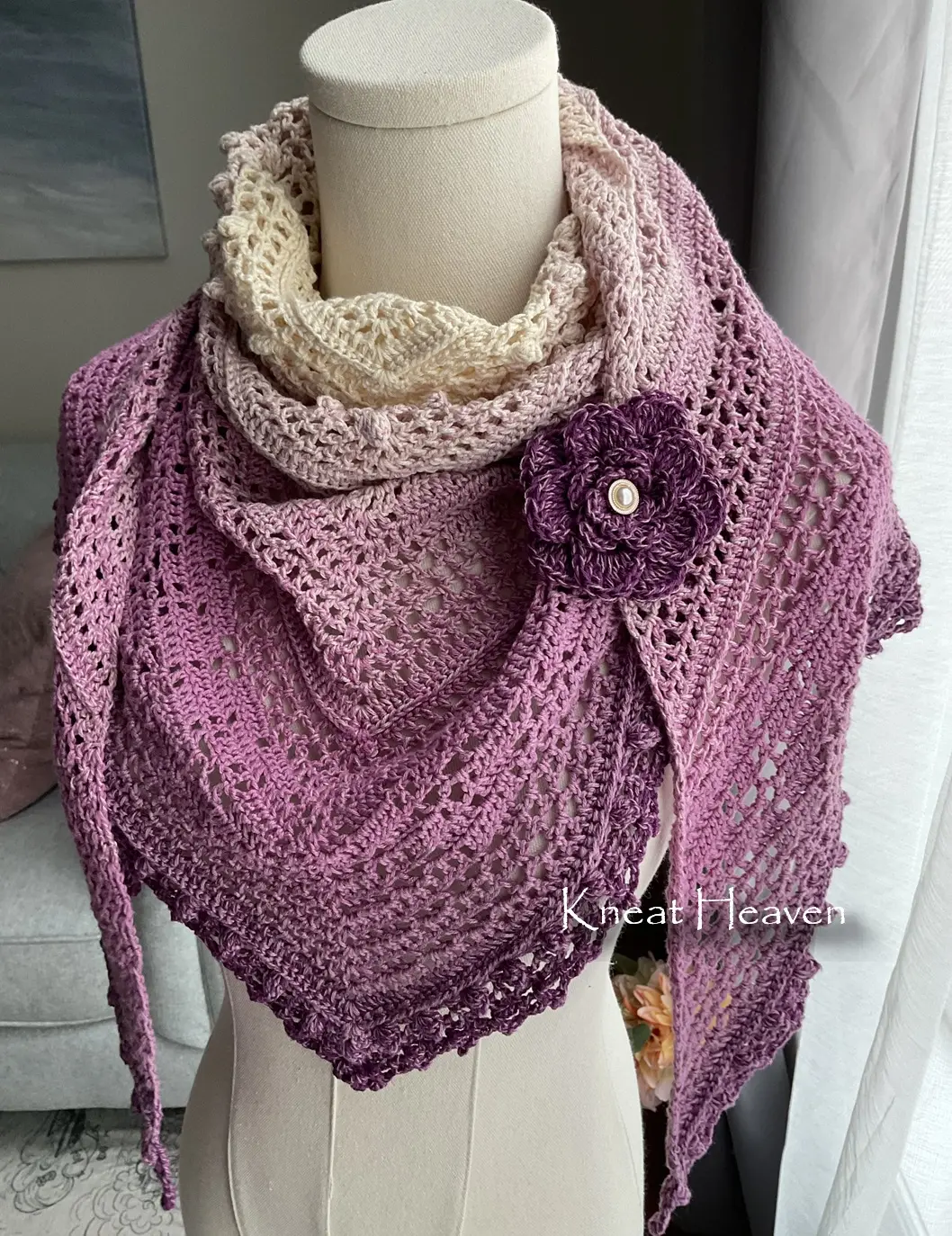 Handmade pink and purple crochet shawl with heart motifs and a crochet rose